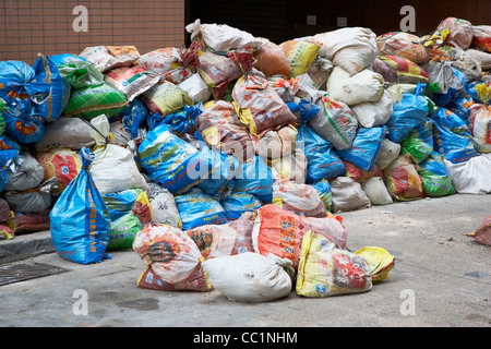 bags of builders rubbish piled up on the side of a street in hong kong hksar china asia Stock Photo