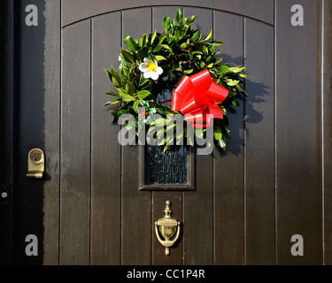 A traditional christmas wreath on the front door of  England Stock Photo