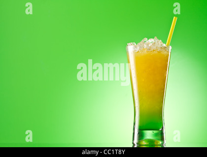 Kivi Pina colada drink cocktail glass isolated on green background Stock Photo