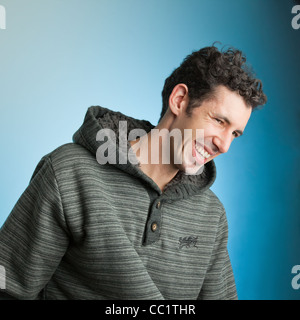 Man in 30's wearing a cap having fun laughing fashion Portrait in studio of Melbourne fashion / fashion's man smiling Stock Photo
