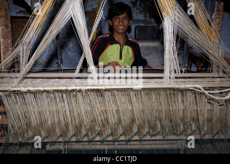 Child working in silk factory, Varanasi (Benares), India Stock Photo