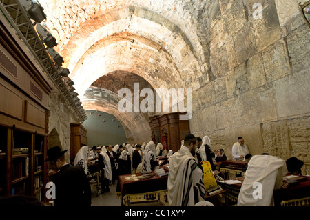 Orthodox Jewish men praying in the inner part of the western wall ( Wilson arch ) in the old city of Jerusalem. Stock Photo