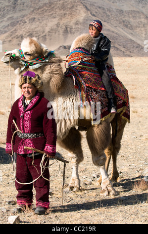 A Kazakh herder with his son in the vast steppe of the Altai region of Western Mongolia. Stock Photo