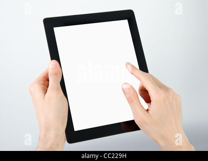 Man hands holding and point on electronic tablet pc with blank screen. Stock Photo