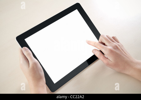 Woman hands holding and point on electronic tablet pc with blank screen. Stock Photo