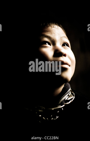 Striking portrait of a traditional Black Hmong boy at the village of Sin Chai near sapa in Northern Vietnam, S E Asia. Stock Photo