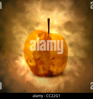 Golden apple glowing against a soft, misty background creates a warm and inviting atmosphere, emphasizing its unique beauty and allure Stock Photo