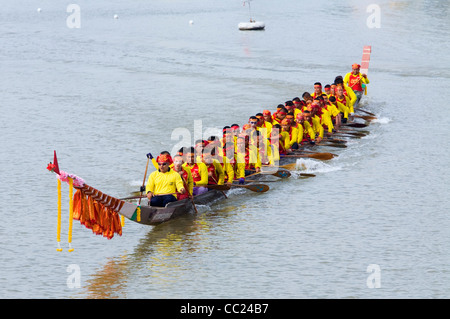 Long-boat team on the Chakrai River during the Phimai Festival boat races.  Phimai, Nakhon Ratchasima province, THAILAND Stock Photo