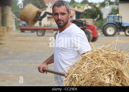 Farmer bailing hay Stock Photo
