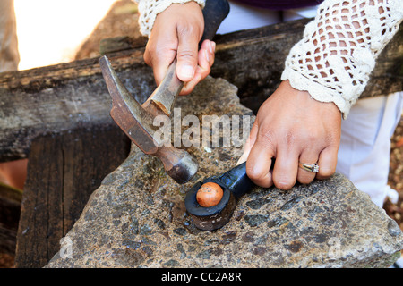 Early tool used to crush & open macadamia nuts. Here the holder and hammer are shown. Molokai, Hawaii, USA. Stock Photo