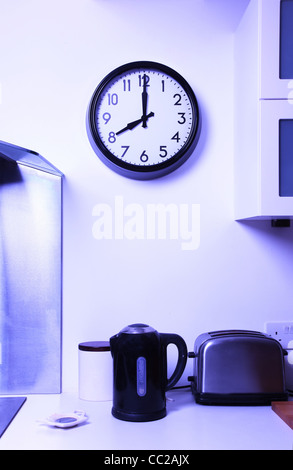 A kitchen wall clock at 8 Stock Photo