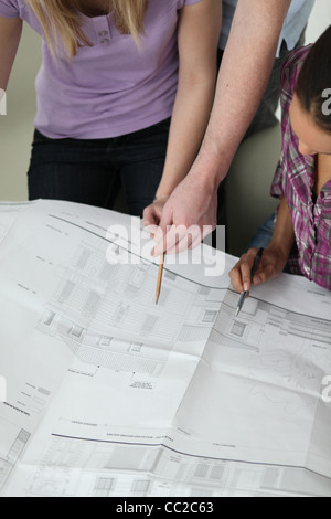 Coworkers discussing architectural plans Stock Photo
