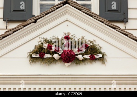 Traditional design of a christmas wreath attached to the front door