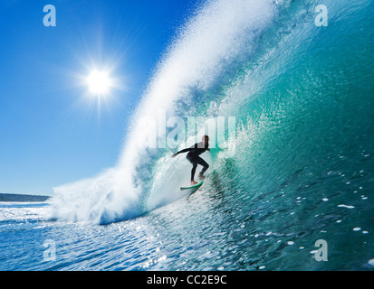 Surfer On Blue Ocean Wave Stock Photo