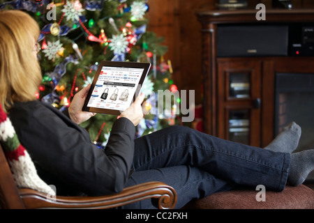 Close up view of a Caucasian woman browsing JCPenney online shopping store on an iPad 2 with wireless internet connection Stock Photo