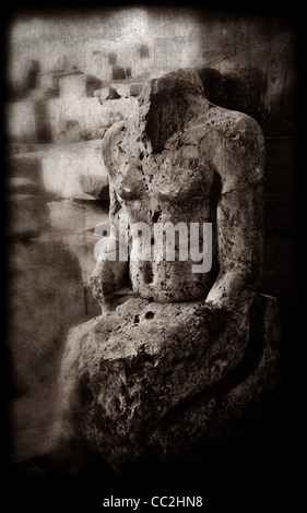 A black and white creative photograph of a ruined statue of an unknown person. Built circa 1400 BC. Karnak Temple, Egypt. Stock Photo
