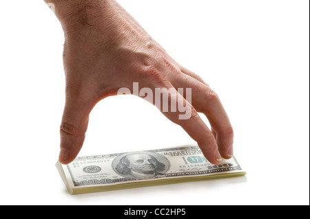 a male hand reaching for a wad of american 100 (hundred) dollar bills Stock Photo