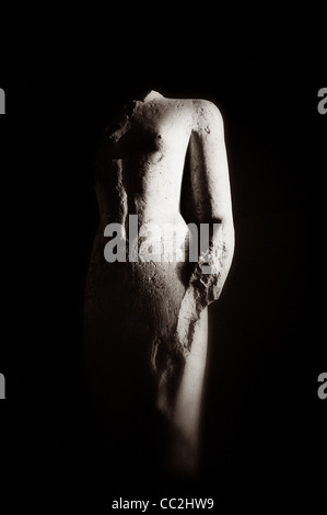 A black and white creative photograph of a ruined statue of an unknown person. Karnak Temple, Egypt. Stock Photo