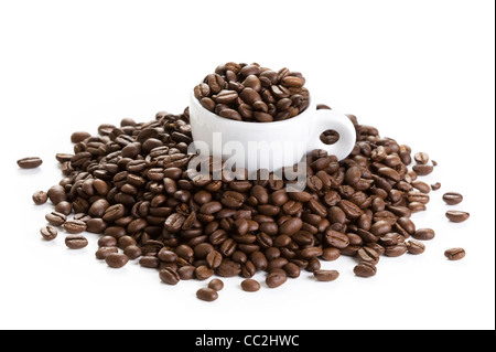 espresso coffee cup filled with and amongst roasted coffee beans isolated on a white background Stock Photo