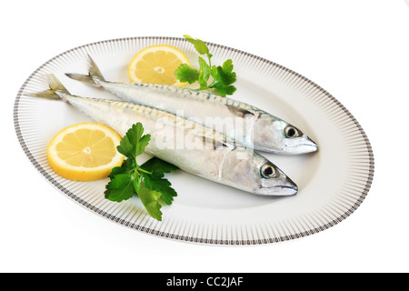 dish with two mackerels with lemon and parsley isolated on white background with clipping path Stock Photo