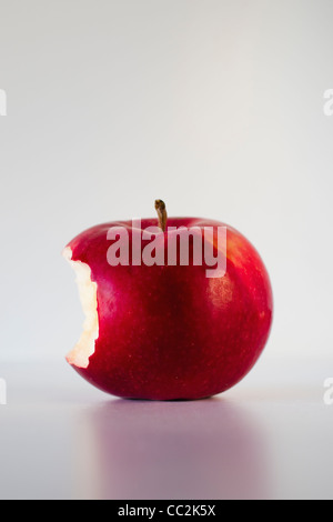 Red apple with missing bite, studio shot Stock Photo