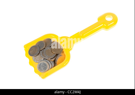 Toy shovel filled with euro coins Stock Photo