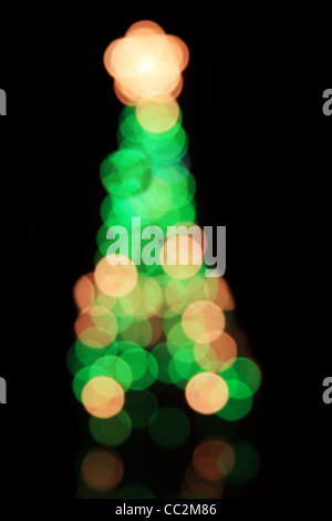 defocussed blurry Christmas tree on black background Stock Photo