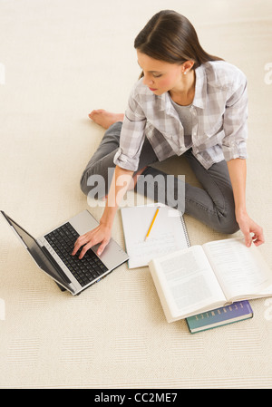 USA, New Jersey, Jersey City, Woman studying at home Stock Photo