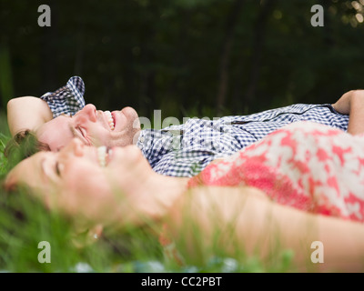 USA, New York, Putnam Valley, Roaring Brook Lake, Couple lying on grass Stock Photo
