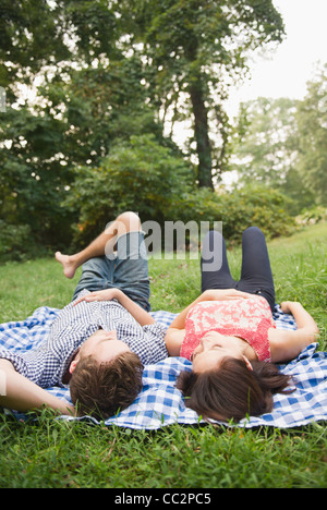 USA, New York, Putnam Valley, Roaring Brook Lake, Couple lying on grass Stock Photo