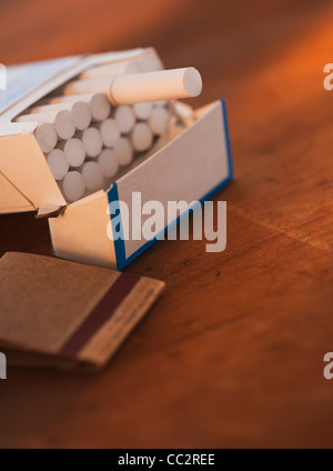 Close up of open cigarette pack and matches Stock Photo