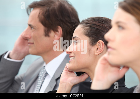 Executives using cellphones Stock Photo