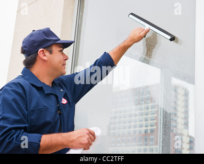 USA, New Jersey, Jersey City, Man cleaning window Stock Photo