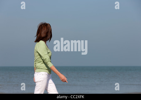 The Netherlands, Domburg, Woman on beach Stock Photo