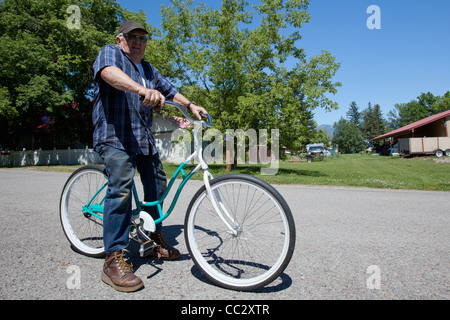 USA, Montana, Whitefish, Portrait of senior man on bike Stock Photo