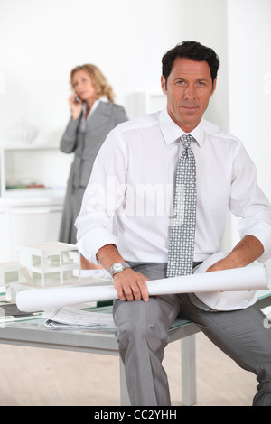 Architect sat on desk Stock Photo