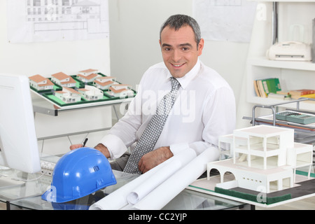 Architect sat working at desk Stock Photo