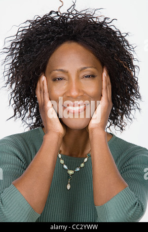 Studio portrait of mature woman Stock Photo