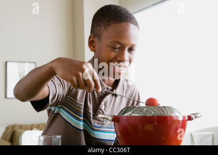 USA, California, Los Angeles, Boy (12-13) preparing dessert Stock Photo