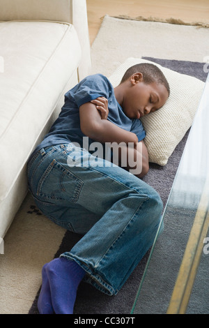 USA, California, Los Angeles, Boy (12-13) sleeping on carpet Stock Photo