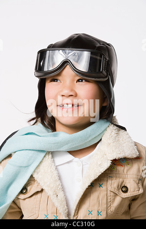 Portrait of smiling boy (8-9) wearing pilot hat and jacket, studio shot Stock Photo