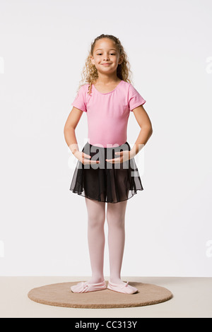 Studio portrait of smiling girl (8-9) in ballet costume Stock Photo