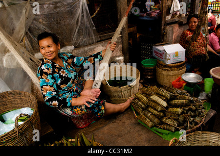 Khmer woman swings in Hammock at an open air market, Kampot Market, Kampot, Cambodia. credit: Kraig Lieb Stock Photo