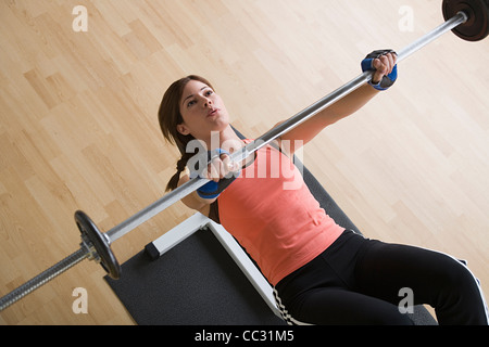 USA, California, Los Angeles, Woman lifting barbell in gym Stock Photo