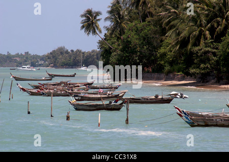 The Wooden Boats Docked At A Beach Near An Island At Sunset Stock Photo 