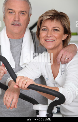 Couple working out in a gym together Stock Photo