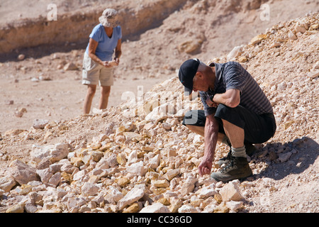 Couple noodling (fossicking) for opals in the outback town of Coober Pedy, South Australia, Australia Stock Photo