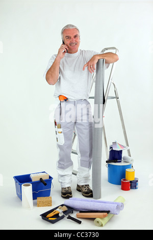 Grey-haired decorator making telephone call Stock Photo