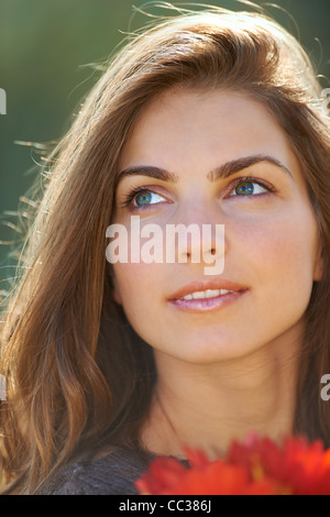 Closeup headshot of a beautiful 20 year old woman outdoor. Stock Photo