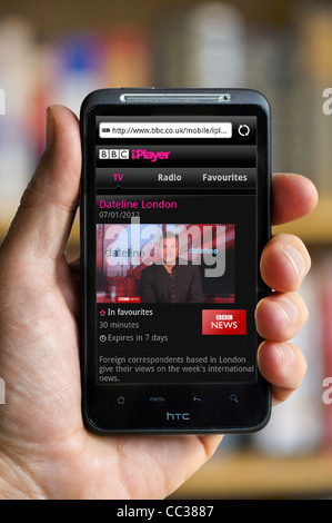 Watching the BBC News Channel on BBC iPlayer on an HTC smartphone Stock Photo